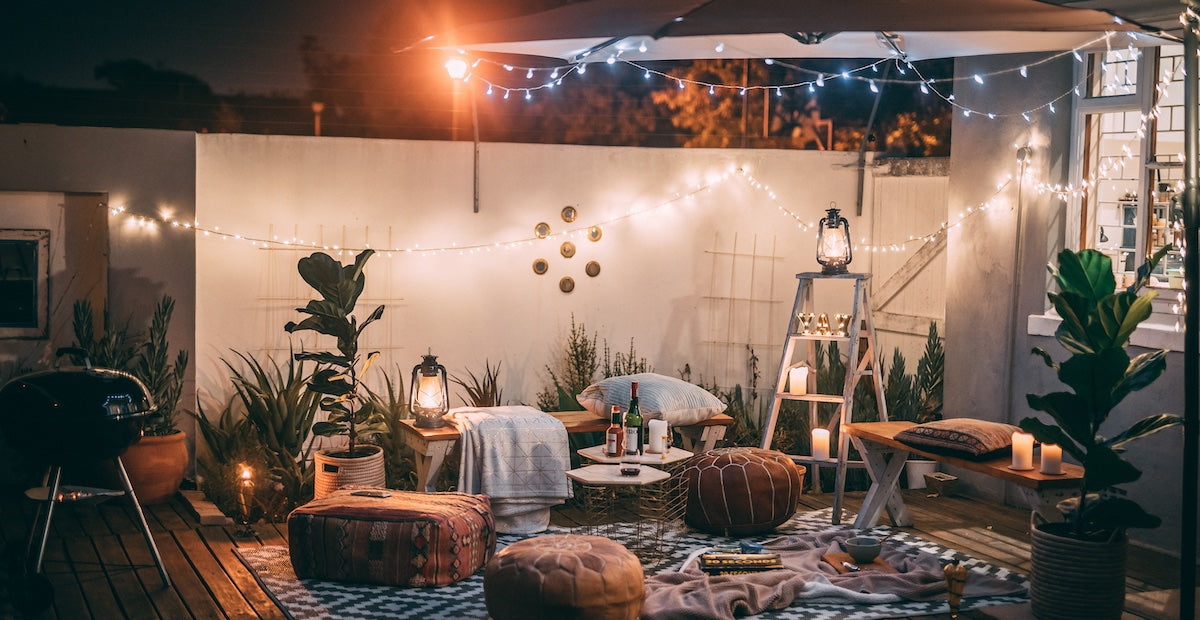 Bohemian style patio lit with lights