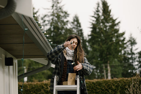 Woman stringing up G30 Bulbs on black trim roof