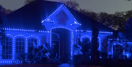 Home decorated with NHL-themed Christmas lights matching team colours