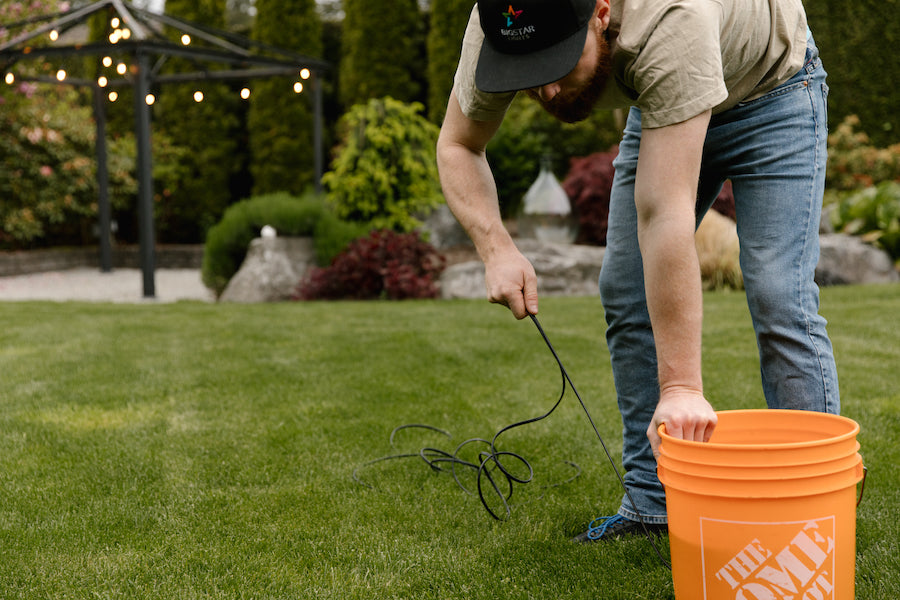 Man touching an orange bucket