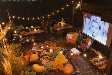 Family watching a classic black-and-white movie in their patio G30 bulbs