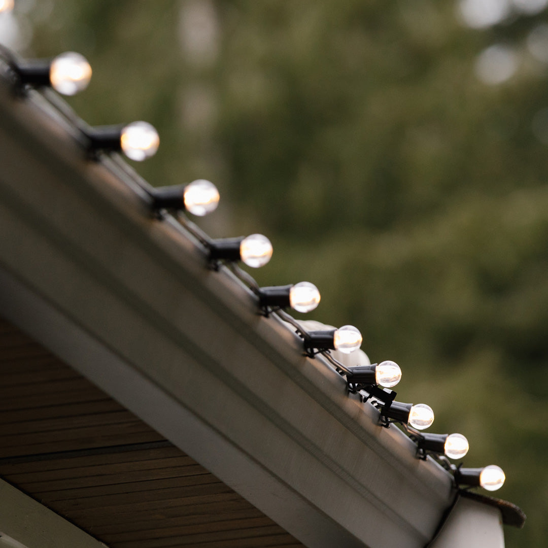 Commercial-Christmas-E17-Base-Wire-With-G30-Lit-Warm-White-Bulbs-On-Roofline-Medium-Shot-In-Use