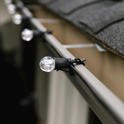 Commercial-Christmas-Multi-Clip-Black-Holding-E17-Base-Wire-With-G30-Bulbs-Onto-A-Gutter-Close-Up-In-Use