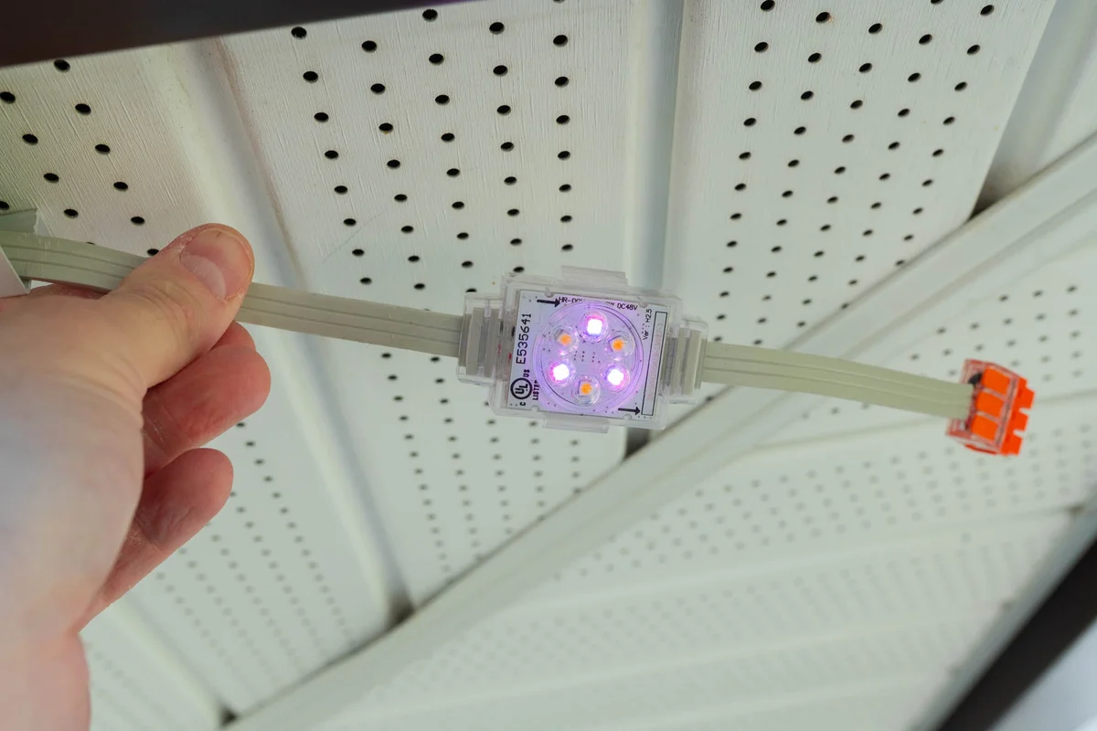 Chromaglow Pro light and track being fitted under an eave