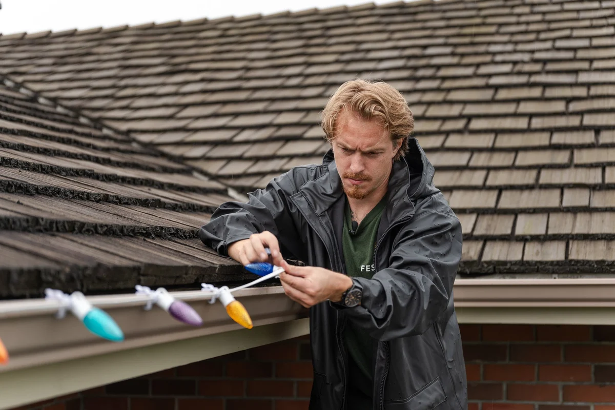 Professional installer working on roofline lights