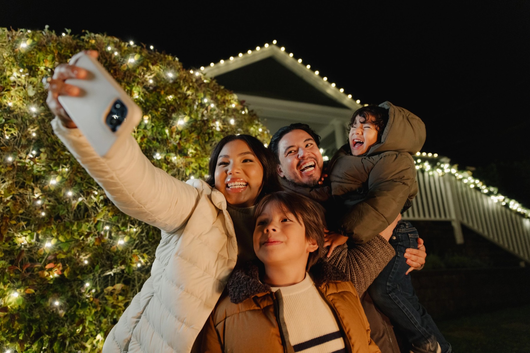 Family enjoying warm holiday lights at home